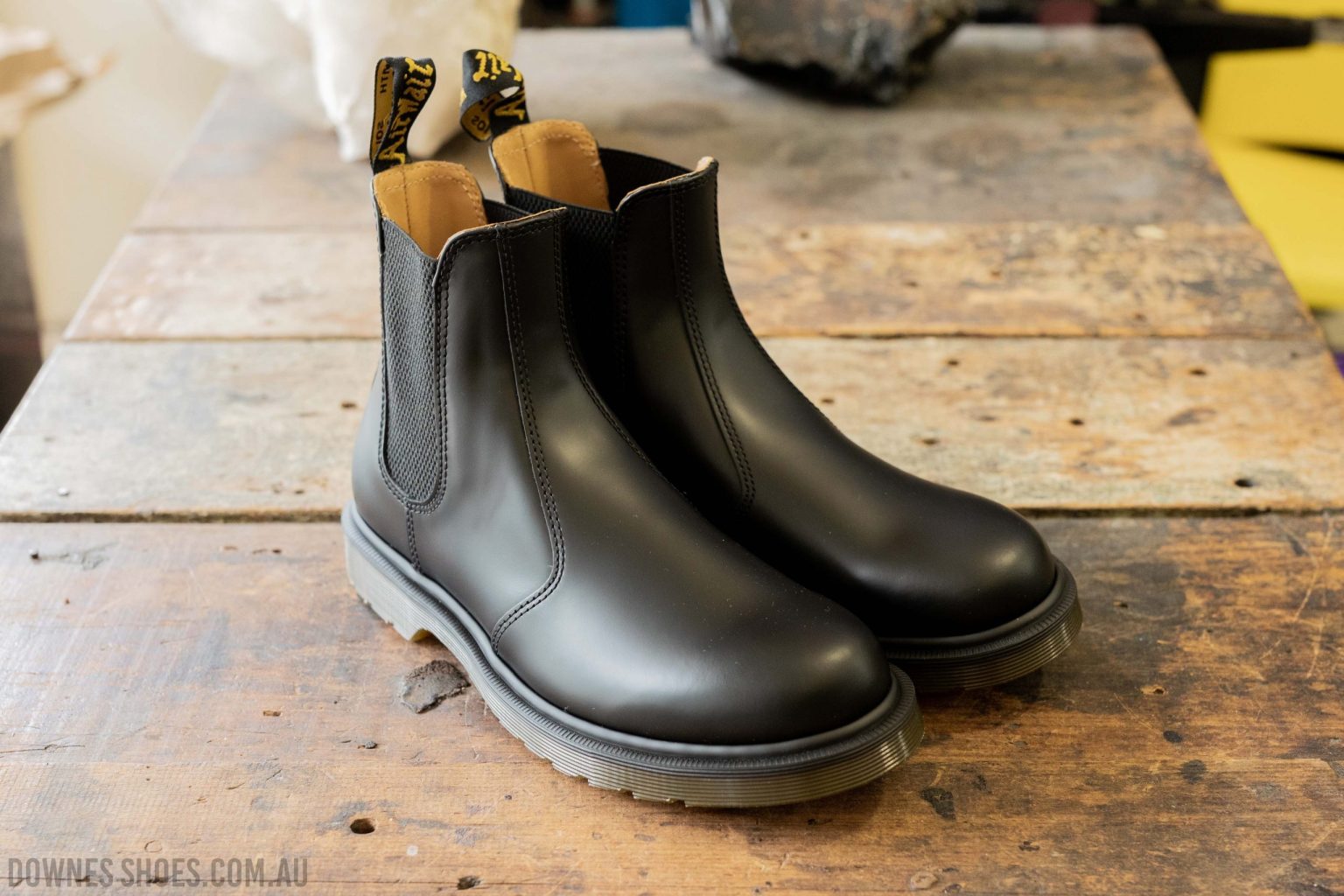 Stylish Dr. Martens Chelsea Boots positioned elegantly on a grassy soccer field