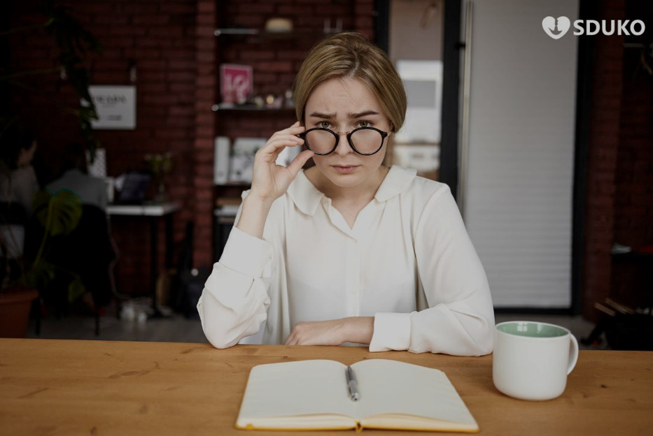 Why Some People Experience More Eye Strain with Certain Anti-Reflective Coatings Woman experiencing eye strain while wearing anti-reflective glasses